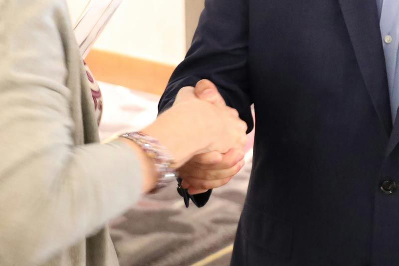 Professionals building authentic business relationships during a conference networking conversation