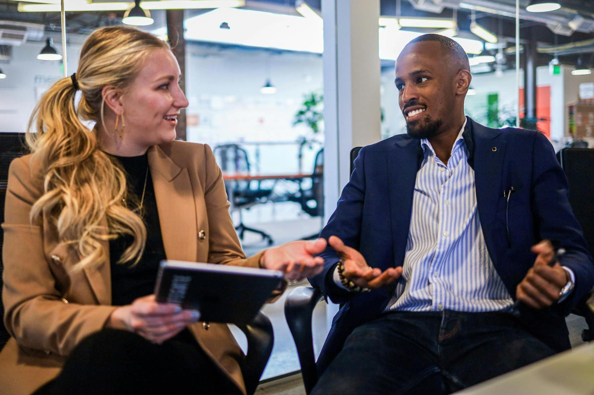 Professional networking conversation between business professionals discussing career opportunities