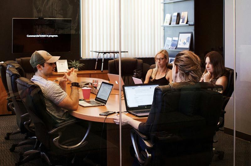 Meeting in conference room going over outplacement services options and benefits.