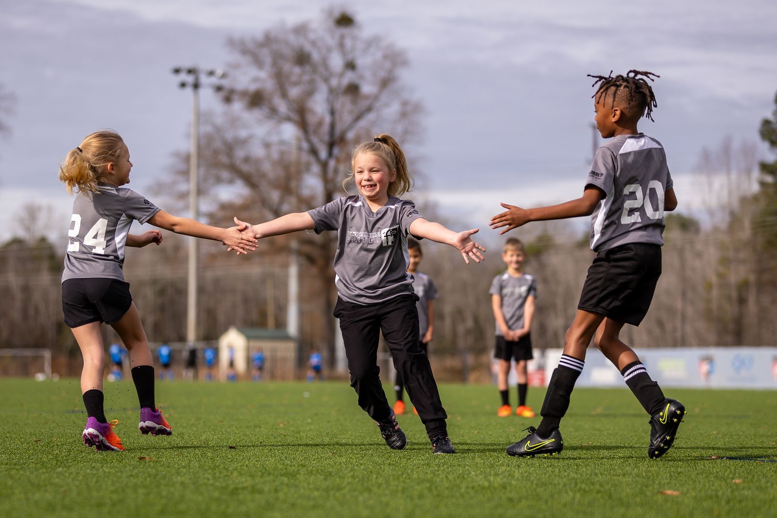 A group of young children are playing recreational soccer on a field at South Carolina United FC.