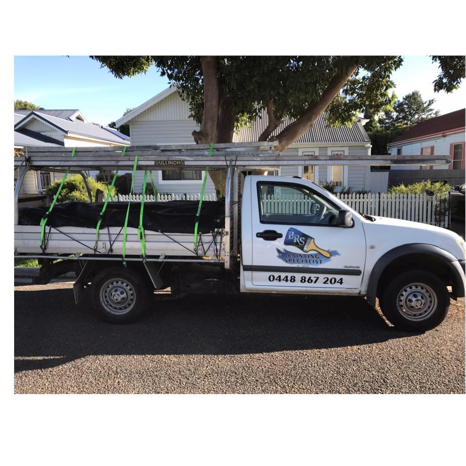 A white truck is parked in front of a house