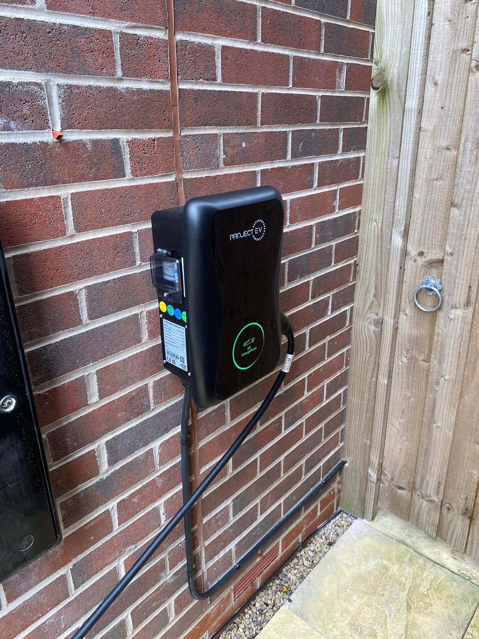 A brick wall with a charging station attached to it.