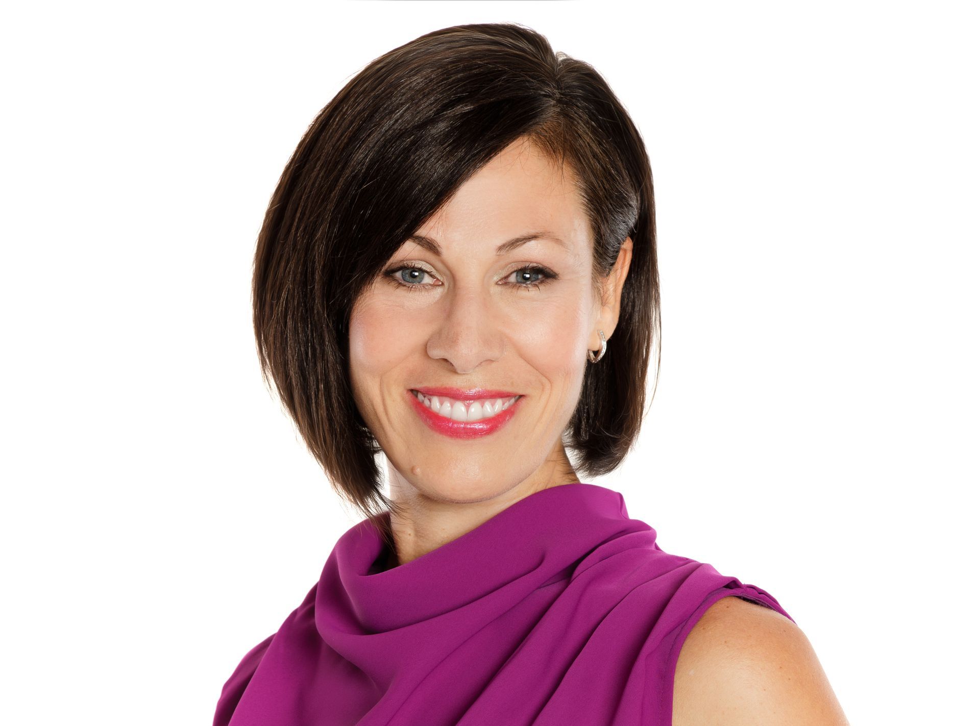 Woman with short dark hair, wearing a purple top, smiling against a white background.