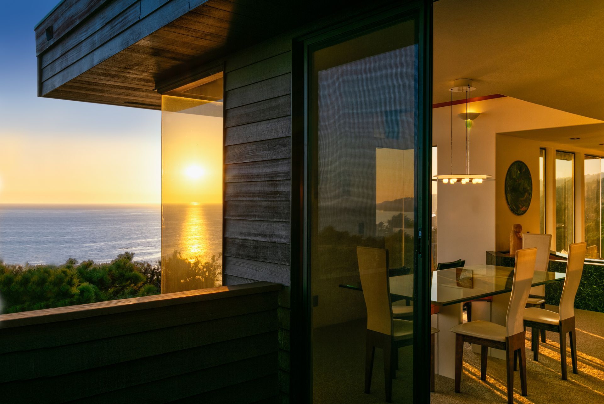 Modern white living room with a beige sectional sofa, arched windows, and a geometric patterned armchair.