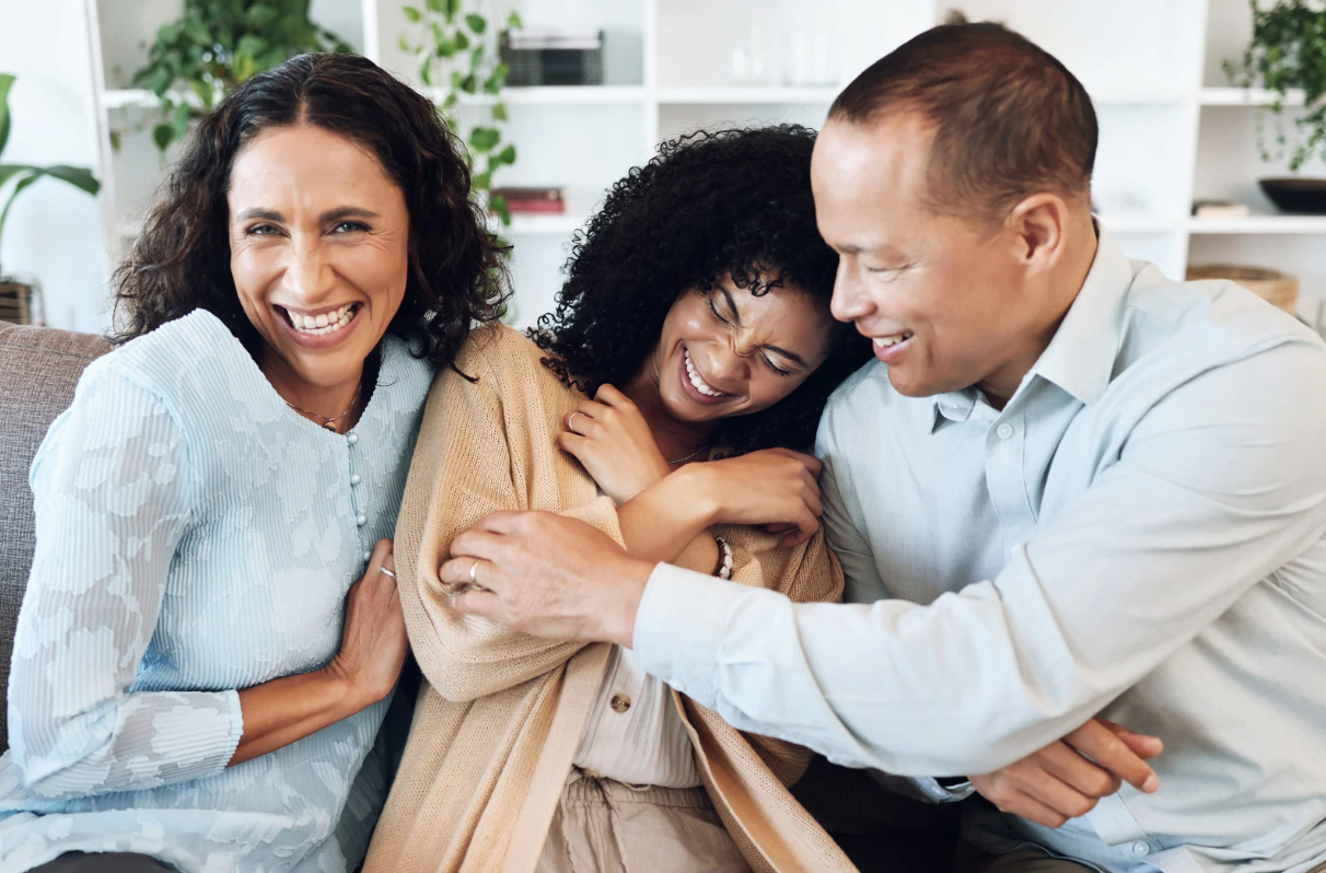 Modern white living room with a beige sectional sofa, arched windows, and a geometric patterned armchair.