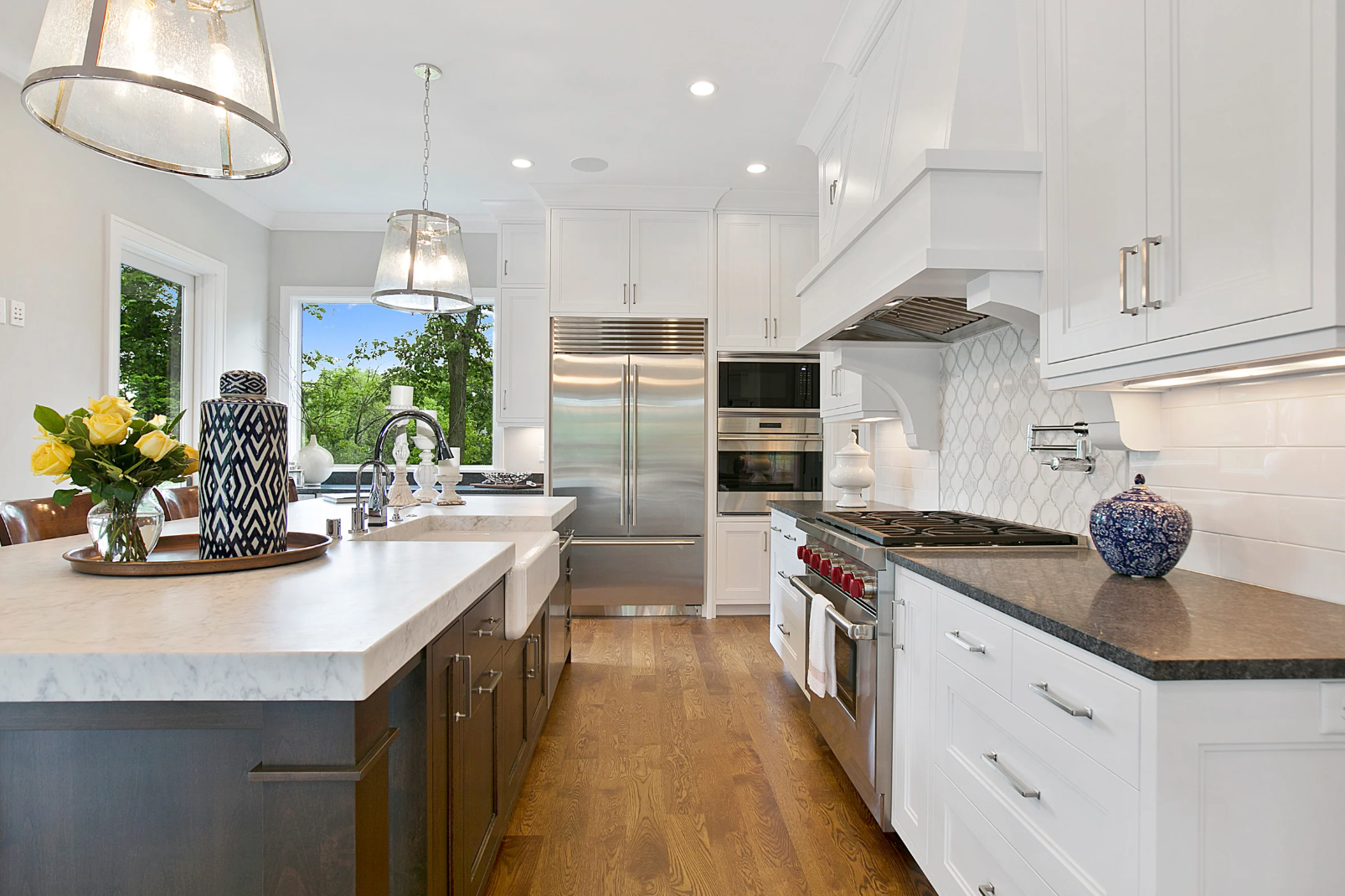 Modern white living room with a beige sectional sofa, arched windows, and a geometric patterned armchair.