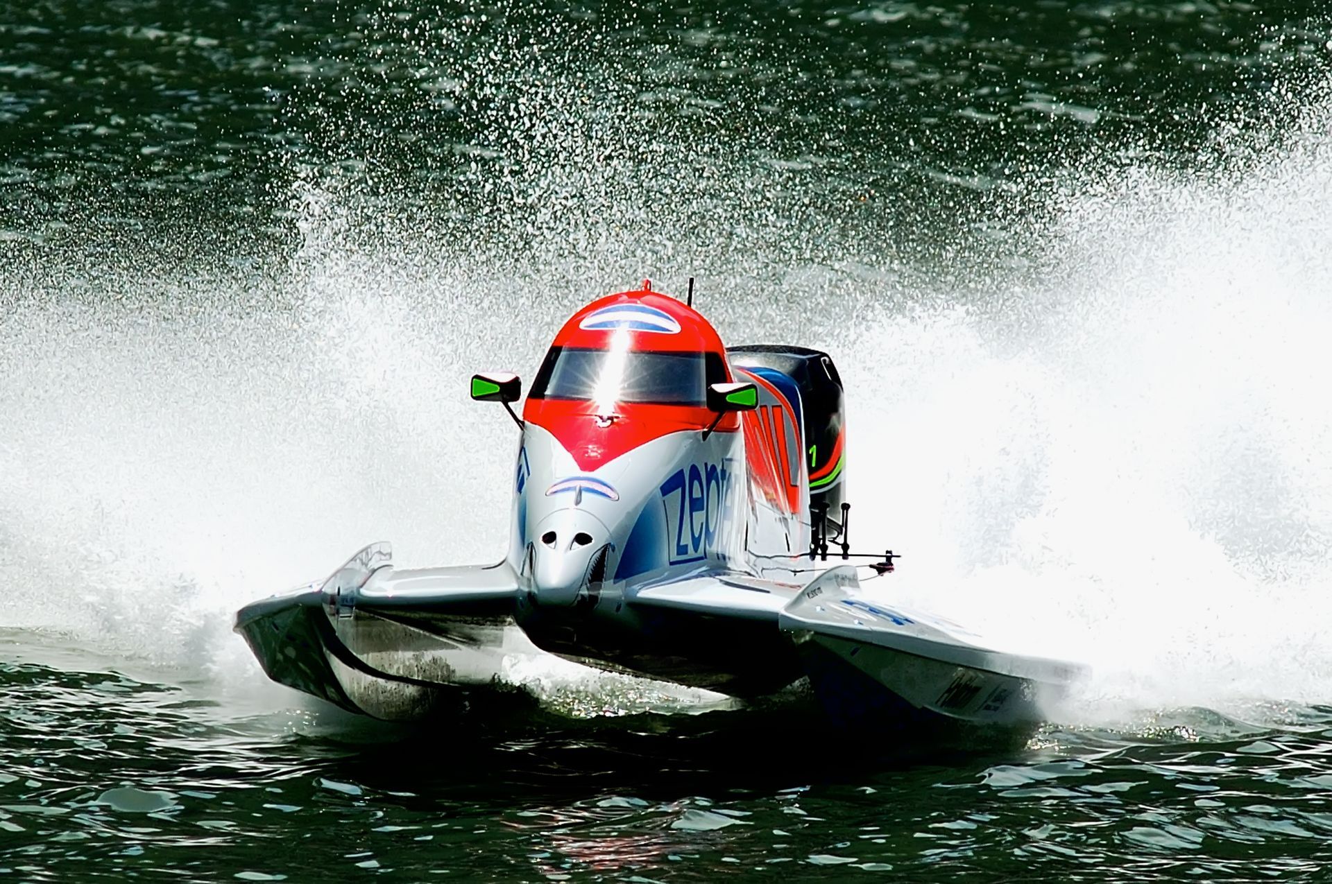 A boat is going through the water at high speed.