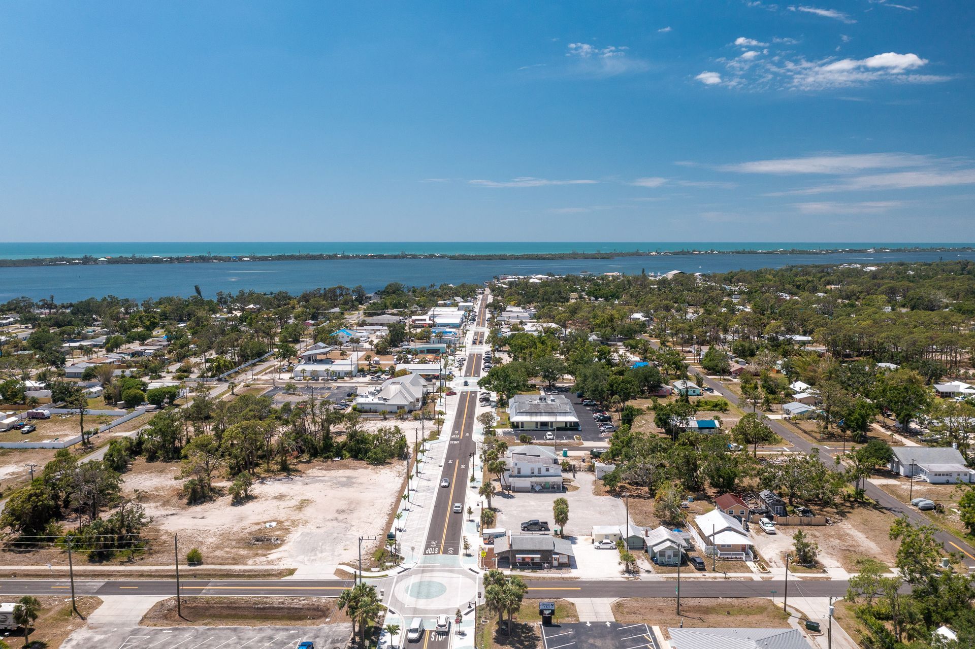 An aerial view of a small town next to the ocean.