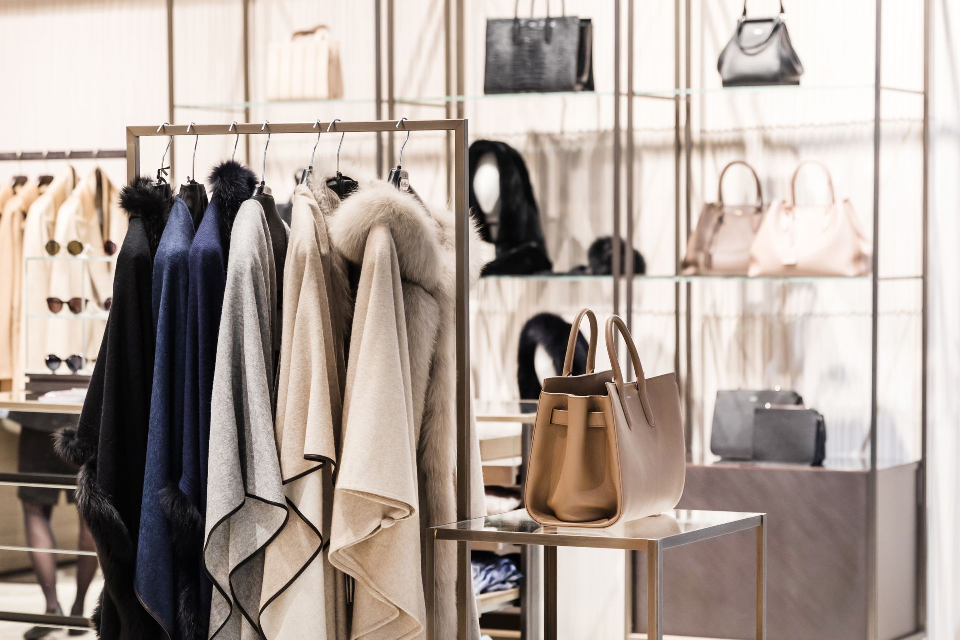 A closet filled with clothes and handbags in a store.