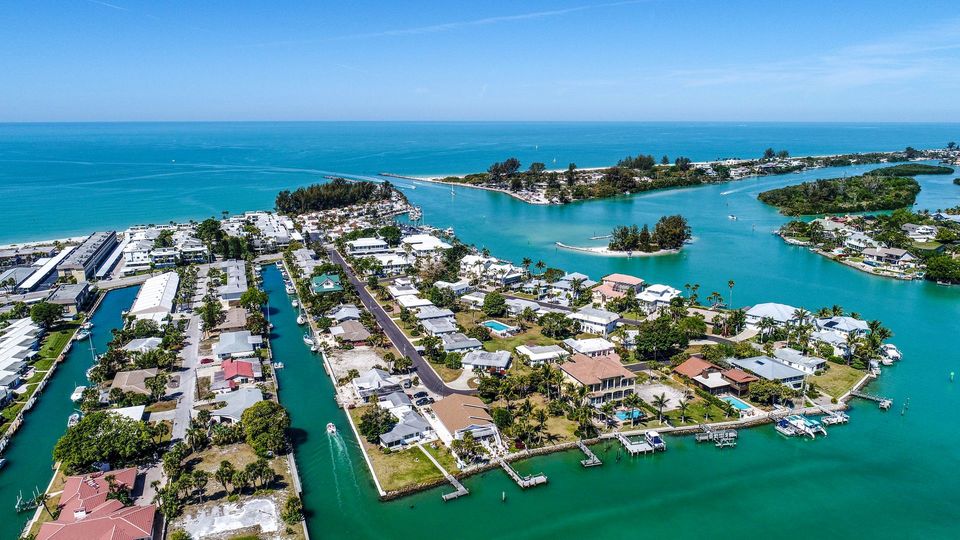 An aerial view of a small island in the middle of a body of water.