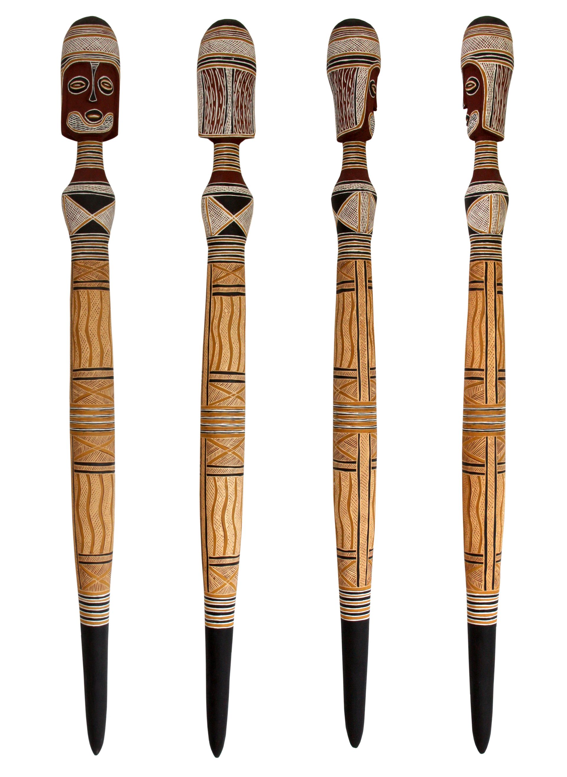 A set of four wooden sticks with faces on them on a white background.
