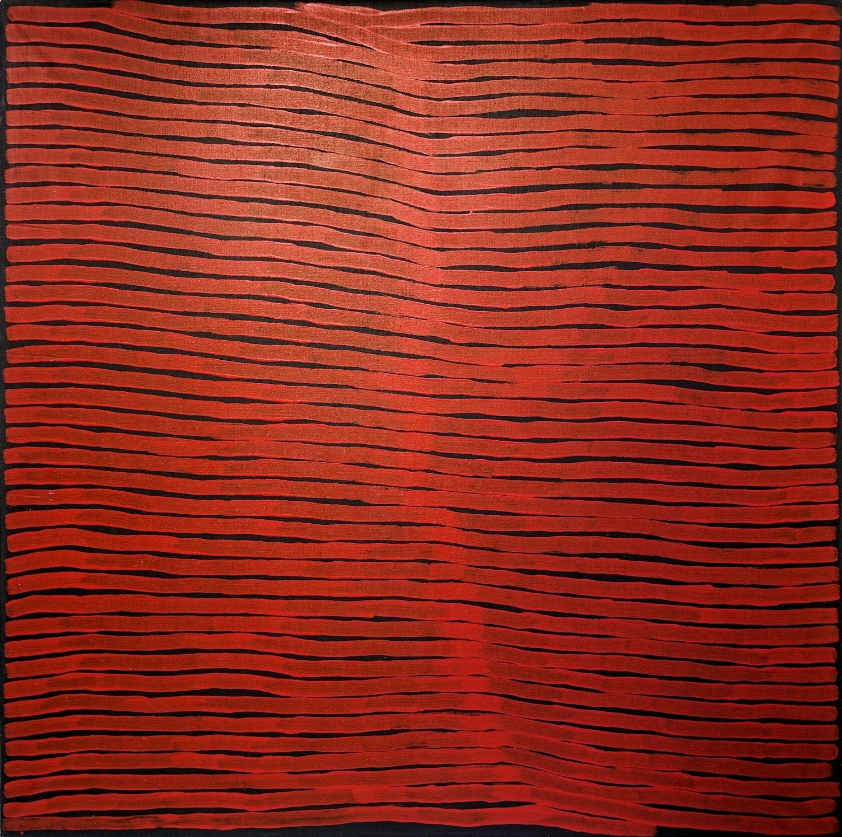 A close up of a red and black painting on a black background.