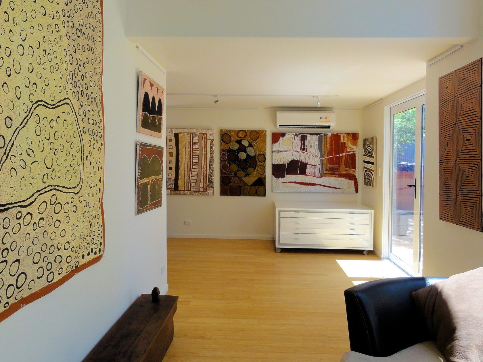 A living room with a couch and paintings on the wall