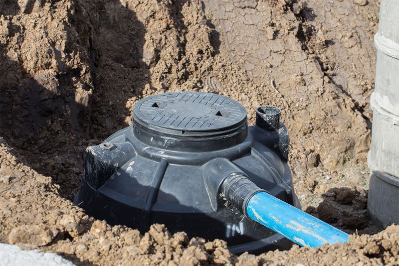 A bulldozer is digging a hole in the ground in a field.