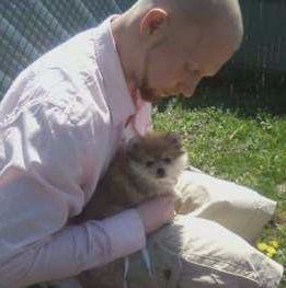 boy holding small Pomeranian
