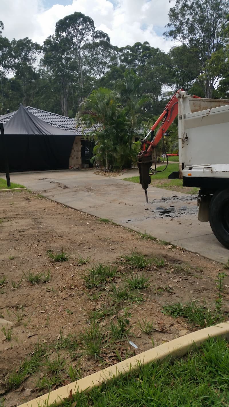 Machinery Removing Old Concrete Driveway — Asphalt and Concreting Services and Solutions in Logan Village, QLD