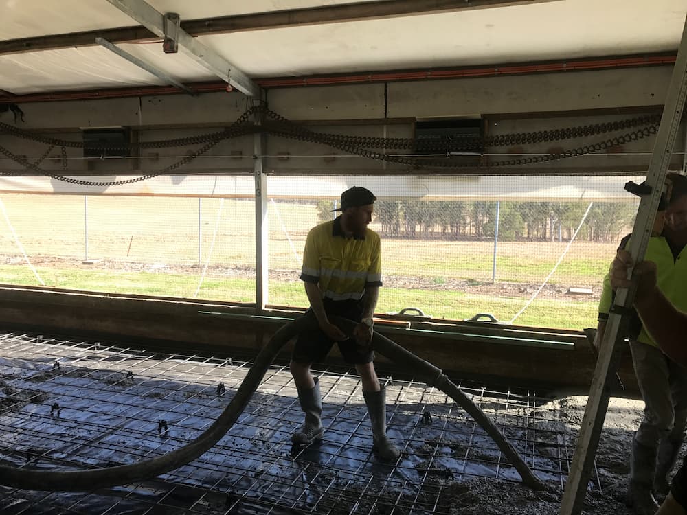 Worker Pouring Wet Concrete — Asphalt and Concreting Services and Solutions in Logan Village, QLD