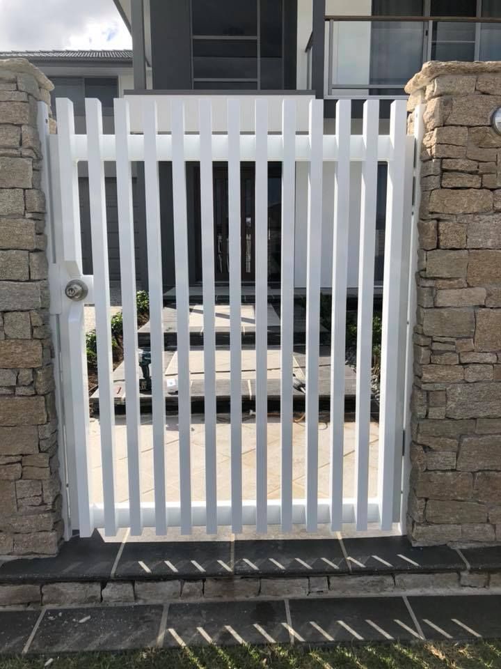 A White Gate is Between a Stone Wall and a House — Sunshine Gates in Kunda Park, QLD