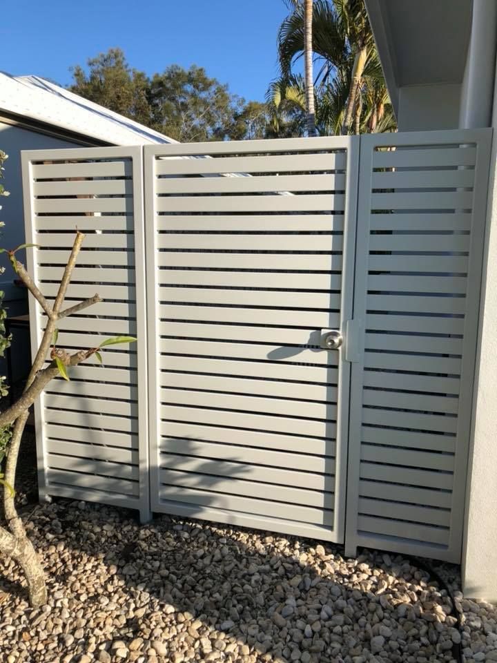 A white fence with a gate in front of a house. — Sunshine Gates in Kunda Park, QLD