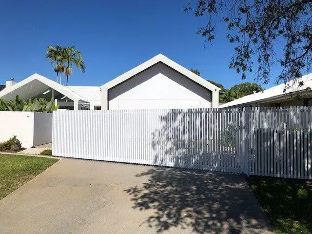 A white house with a white fence in front of it — Sunshine Gates in Kunda Park, QLD