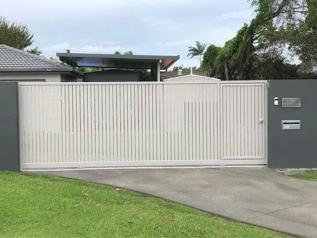 A White Gate is Sitting Next to a White Wall — Sunshine Gates in Kunda Park, QLD