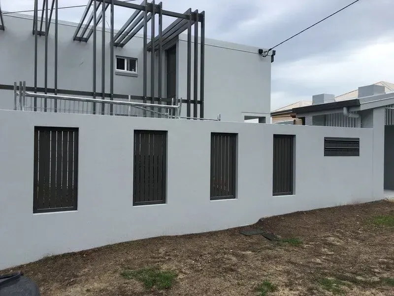 A Balcony With a Chair and a Table Under a White Roof — Sunshine Gates in Kunda Park, QLD