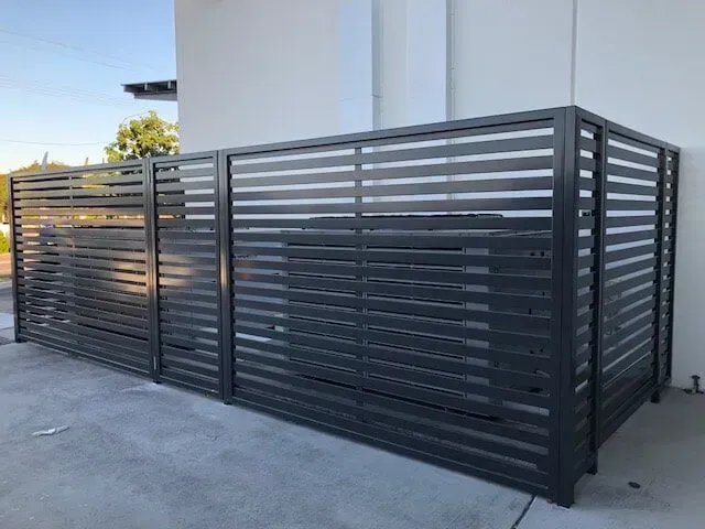 A black metal fence is sitting on the side of a building — Sunshine Gates in Kunda Park, QLD