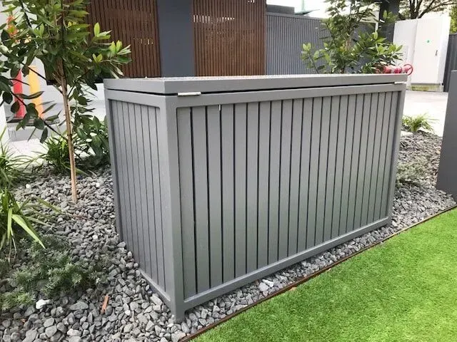A gray wooden box is sitting on top of a lush green lawn. — Sunshine Gates in Kunda Park, QLD