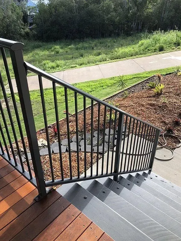 A set of stairs leading up to a deck with a metal railing. — Sunshine Gates in Kunda Park, QLD