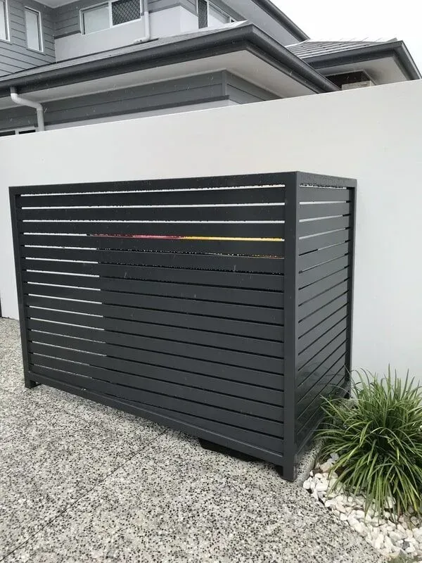 A black fence is sitting in front of a house. — Sunshine Gates in Kunda Park, QLD