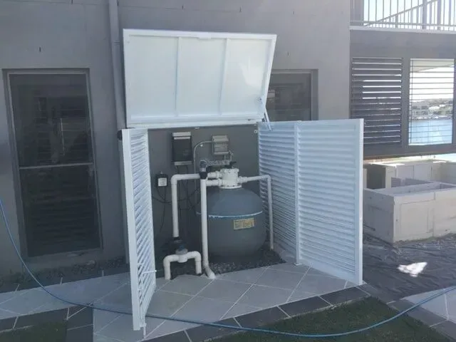 A swimming pool filter is sitting inside of a white box. — Sunshine Gates in Kunda Park, QLD