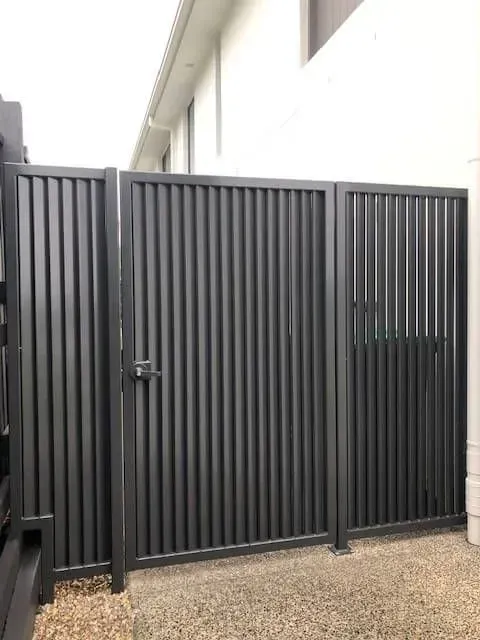 A black metal gate is sitting in front of a house. — Sunshine Gates in Kunda Park, QLD