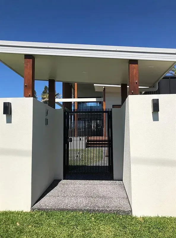 A white house with a black gate in front of it. — Sunshine Gates in Kunda Park, QLD