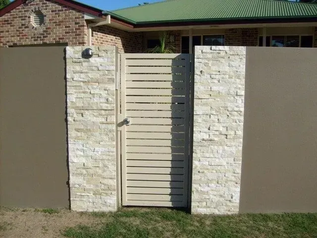 A fence with a gate in front of a house. — Sunshine Gates in Kunda Park, QLD