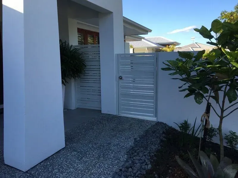A white house with a white gate in front of it. — Sunshine Gates in Kunda Park, QLD