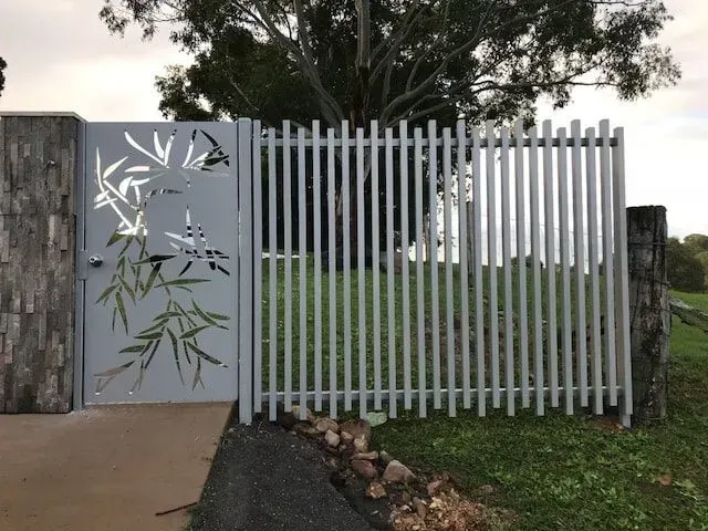 A gate with a bamboo design on it is surrounded by a fence. — Sunshine Gates in Kunda Park, QLD