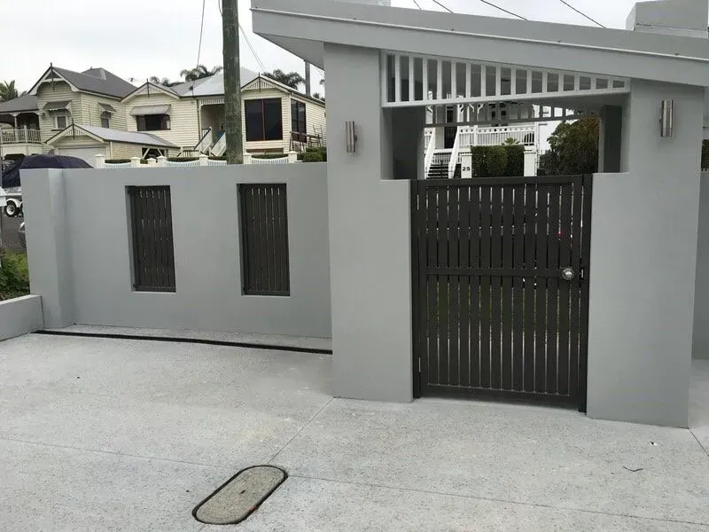 A white fence with a black gate in front of it. — Sunshine Gates in Kunda Park, QLD