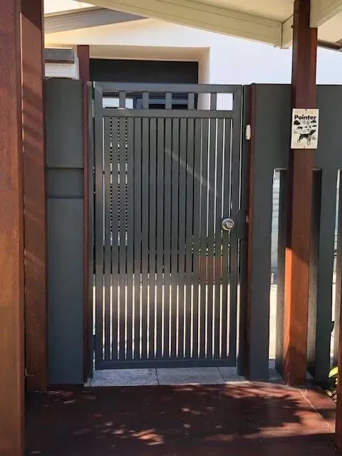 A gate with a sign on it that says no dogs allowed. — Sunshine Gates in Kunda Park, QLD