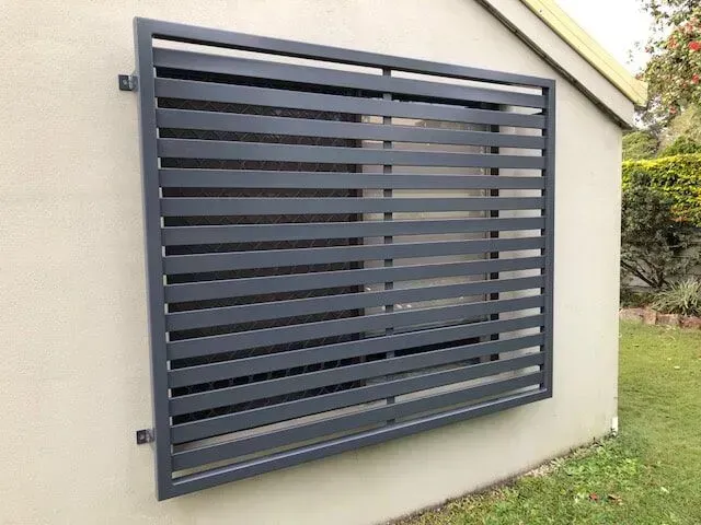 A large window with a fence around it on the side of a building. — Sunshine Gates in Kunda Park, QLD