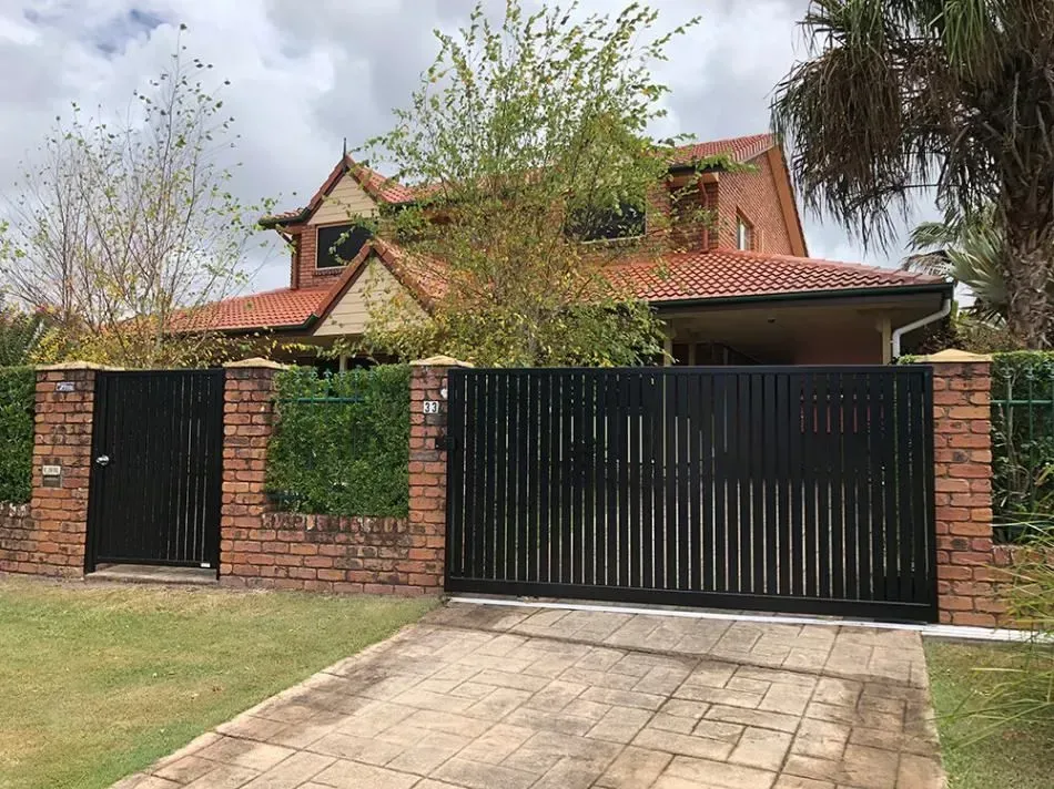 A large house with a black gate in front of it.— Sunshine Gates in Kunda Park, QLD