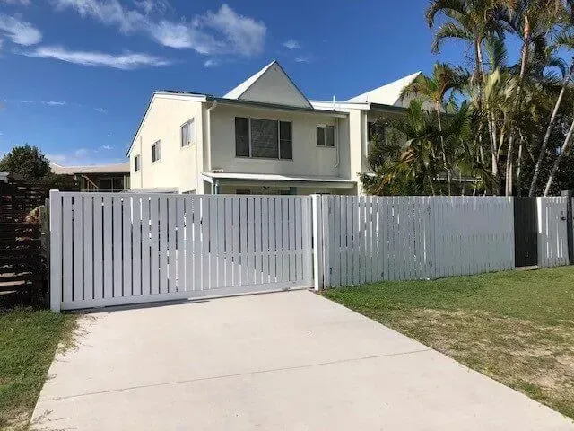 A white house with a white fence in front of it. — Sunshine Gates in Kunda Park, QLD