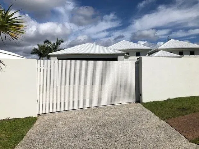 A white house with a white fence and a white gate. — Sunshine Gates in Kunda Park, QLD