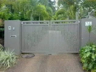 A sliding gate is open to a driveway in front of a house. — Sunshine Gates in Kunda Park, QLD