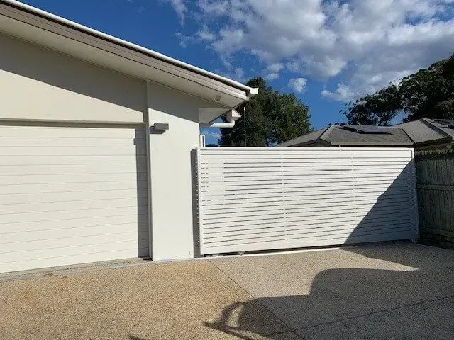 A white house with a white fence in front of it — Sunshine Gates in Kunda Park, QLD