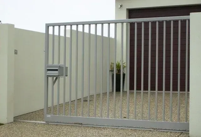 A sliding gate is open to a driveway in front of a house. — Sunshine Gates in Kunda Park, QLD
