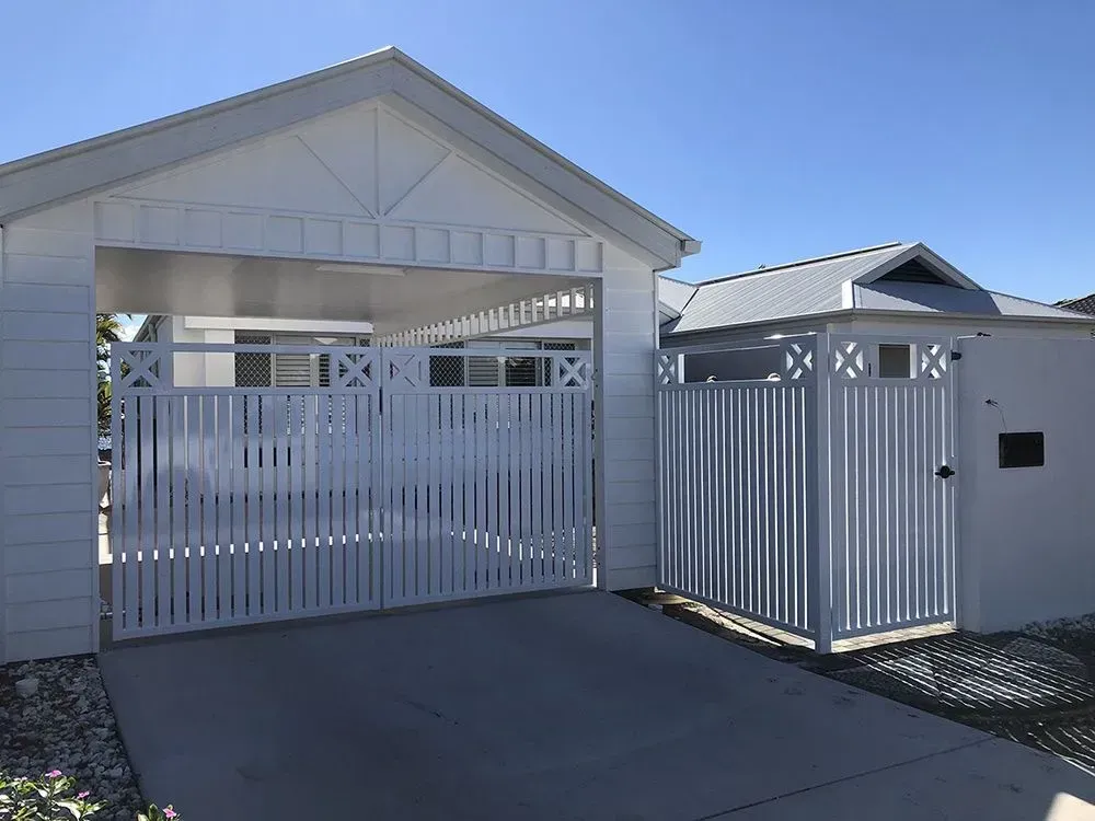 A white house with a white garage door and a white gate. — Sunshine Gates in Kunda Park, QLD
