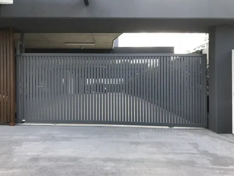 A black sliding gate is open to a driveway. — Sunshine Gates in Kunda Park, QLD