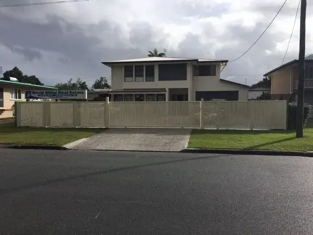 A house with a white fence surrounding it. — Sunshine Gates in Kunda Park, QLD