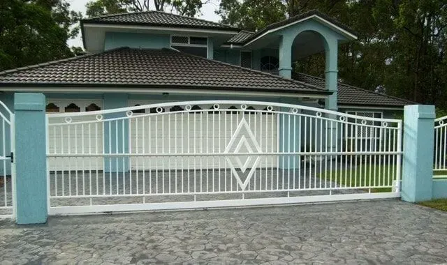 A large house with a white gate in front of it. — Sunshine Gates in Kunda Park, QLD