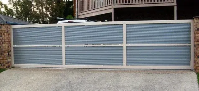 A sliding gate is sitting in front of a house. — Sunshine Gates in Kunda Park, QLD